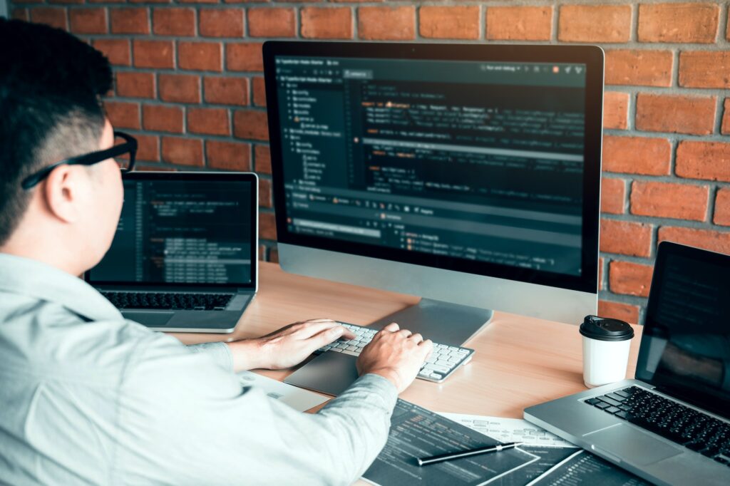 Asian man working code program developer computer web development working